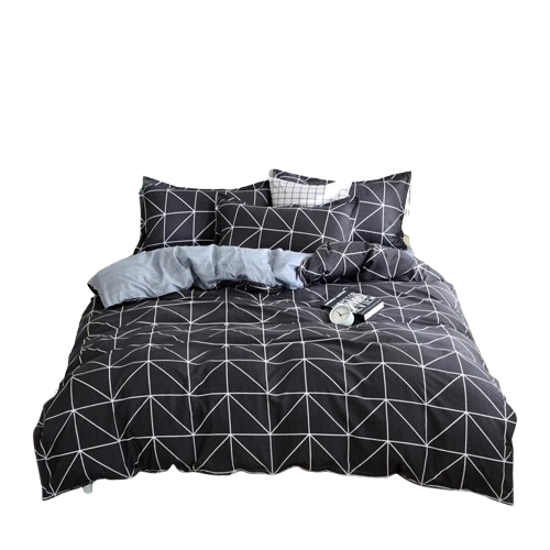 Housse de couette anthracite à motif triangles blancs avec envers gris clair à micro-points, installée sur un lit double dans une chambre contemporaine.