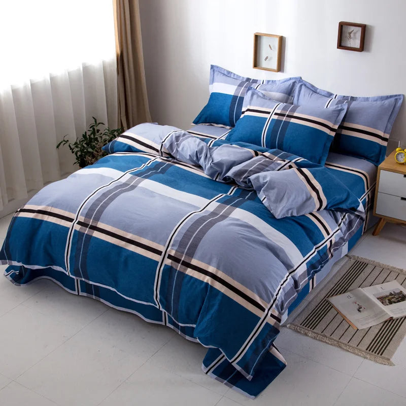 Housse de couette en coton 200 TC à larges carreaux bleu profond et gris clair posée sur un lit moderne.