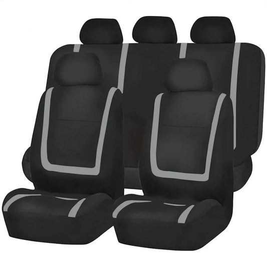 Set universel de housses de siège auto en polyester noir avec passepoil gris, couvrant sièges avant, banquette et appuie-têtes.
